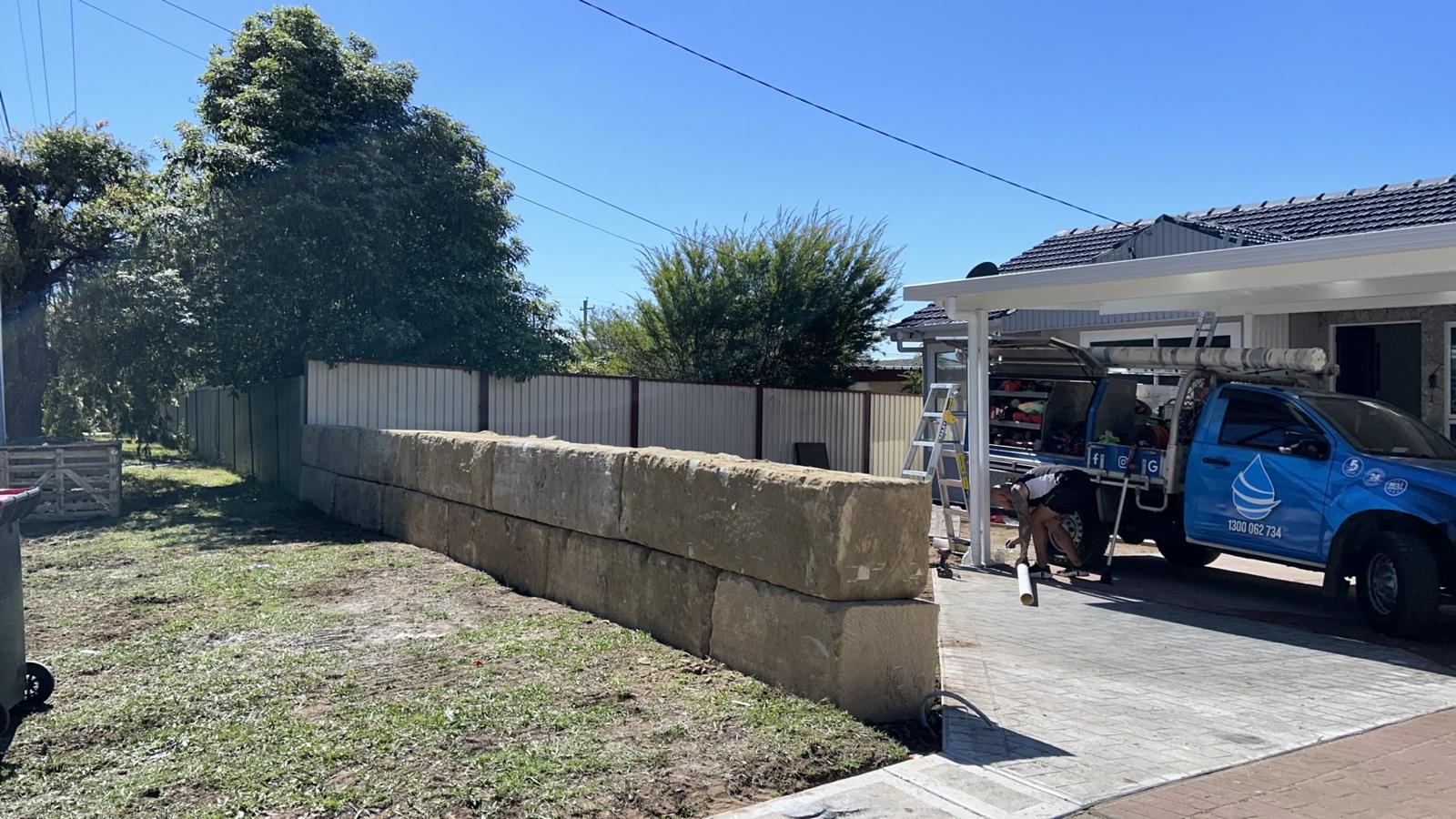 Street front sandstone block wall finished on a new home site